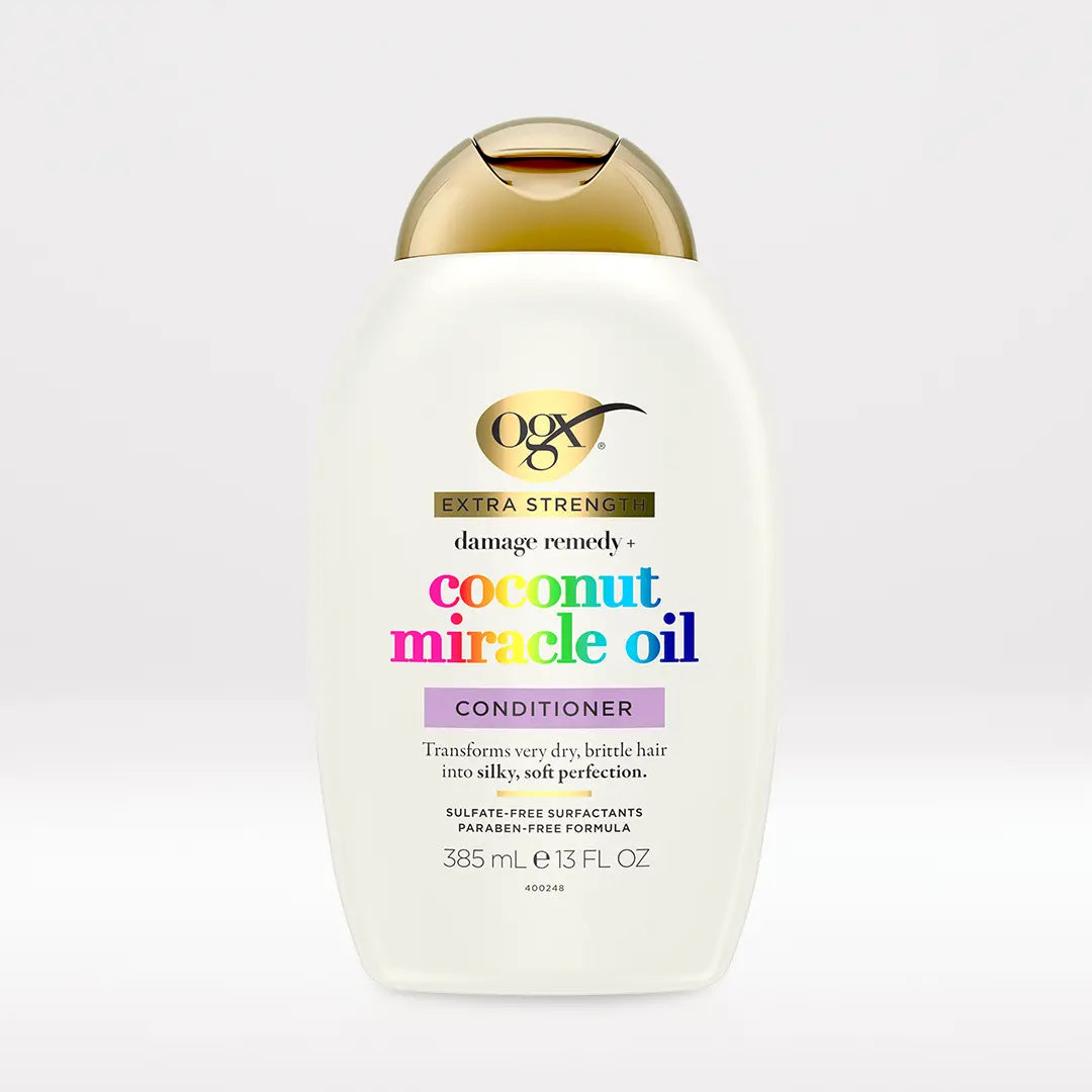 OGX Extra Strength Coconut Miracle Oil Conditioner 13 oz bottle on light neutral background