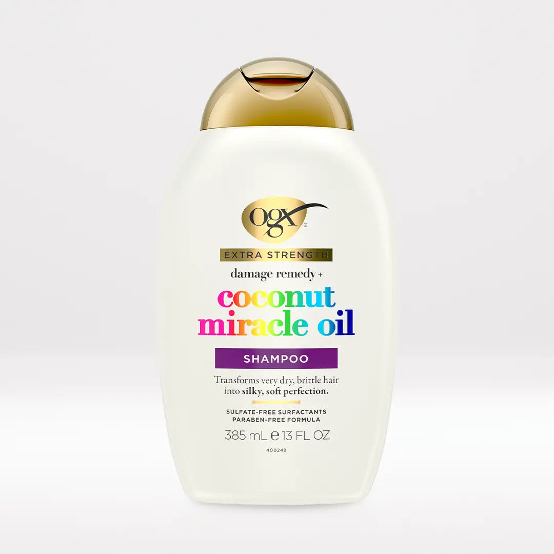 OGX Extra Strength Coconut Miracle Oil Shampoo 13 oz bottle on light neutral background